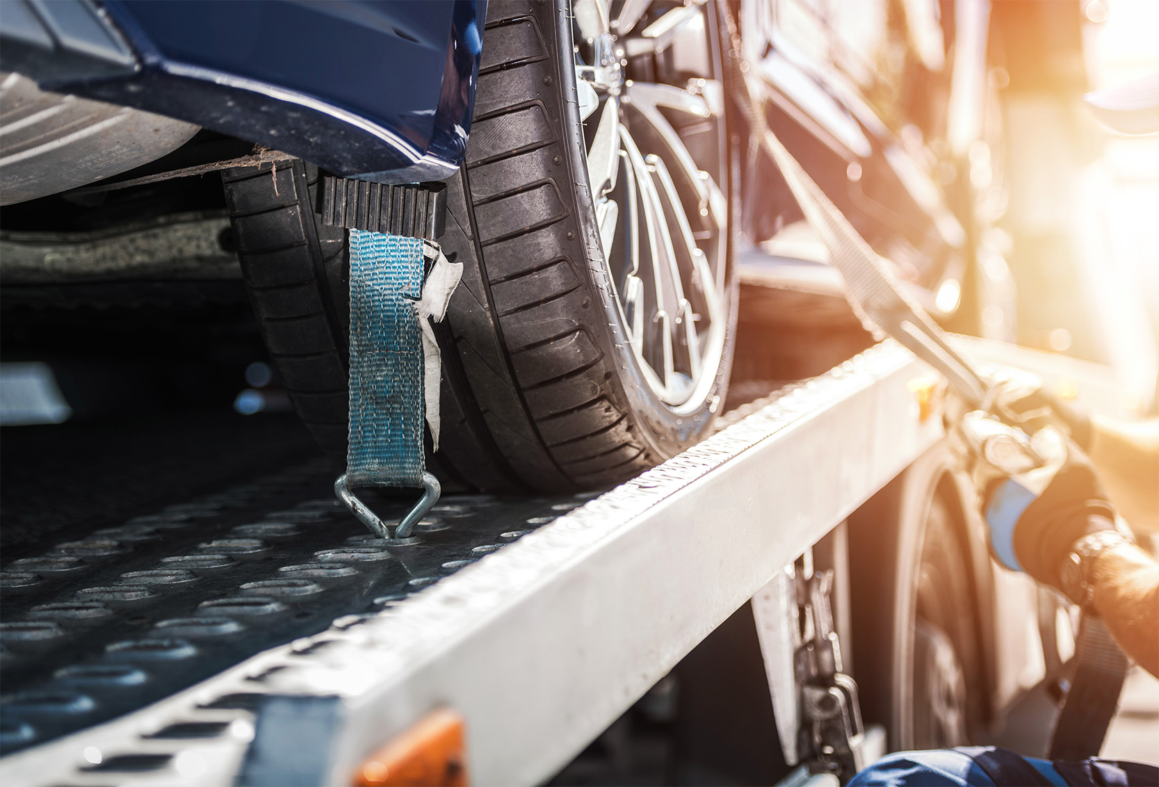 A car safely fastened on a towing truck.